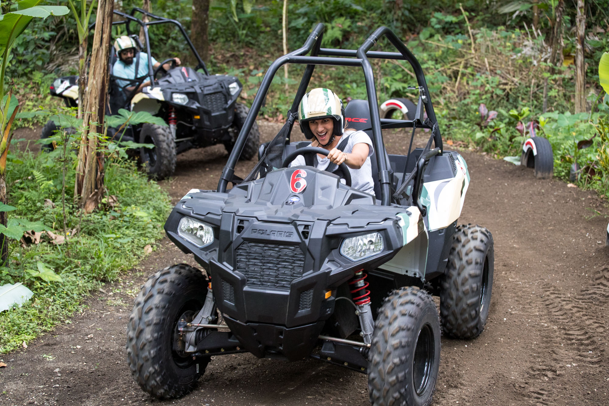 Adventurers on ATVs navigate a dirt road in Ubud’s Jungle Trails, enjoying the thrill of the ride through scenic landscapes.